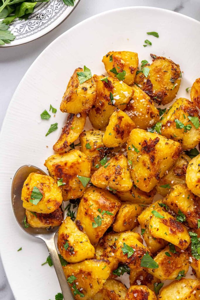 Herbed English roast potatoes served family-style on a platter
