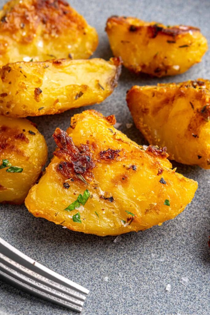 super close up of Crispy English roast potatoes served on a gray plate