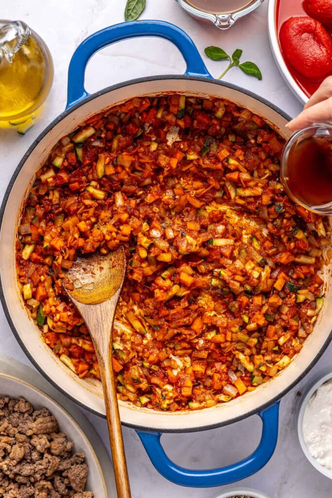 Red wine vinegar added to the pot for homemade vodka sauce, overhead view