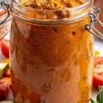 Finished vodka sauce with hidden vegetables in a glass jar, garnished and photographed from above