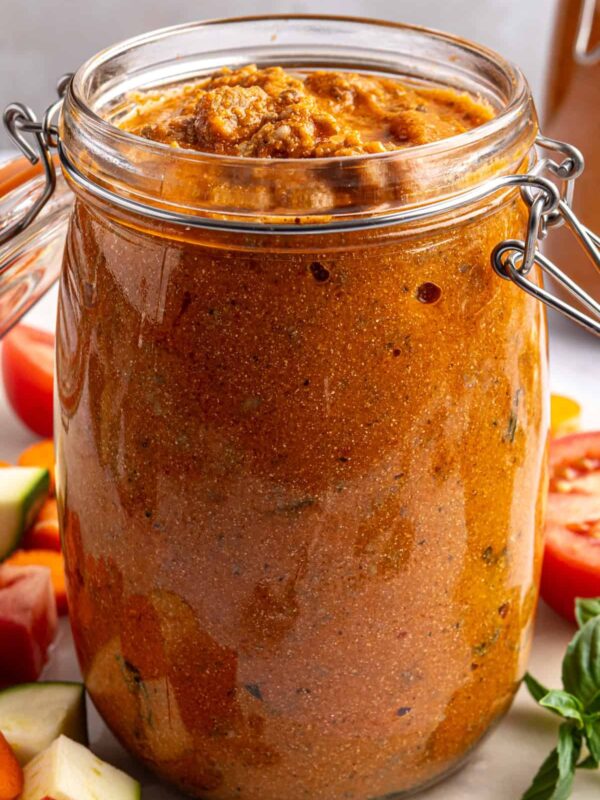 Finished vodka sauce with hidden vegetables in a glass jar, garnished and photographed from above