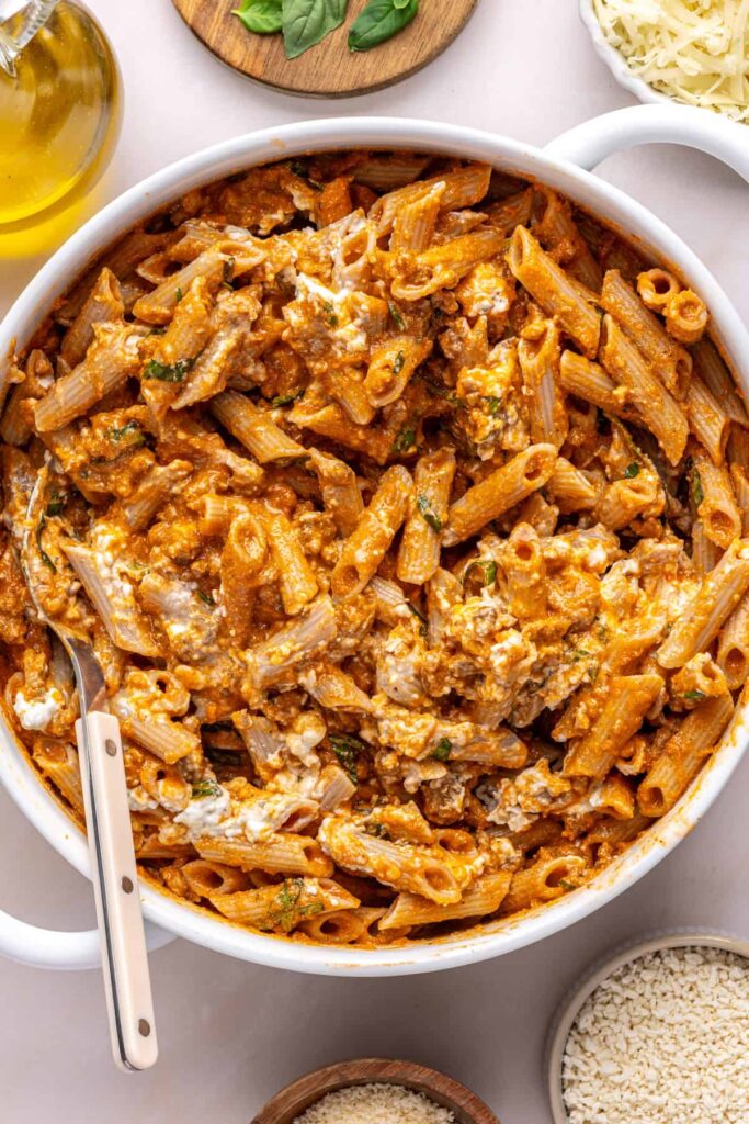 Cheesy pasta mixture stirred together before baking easy baked ziti