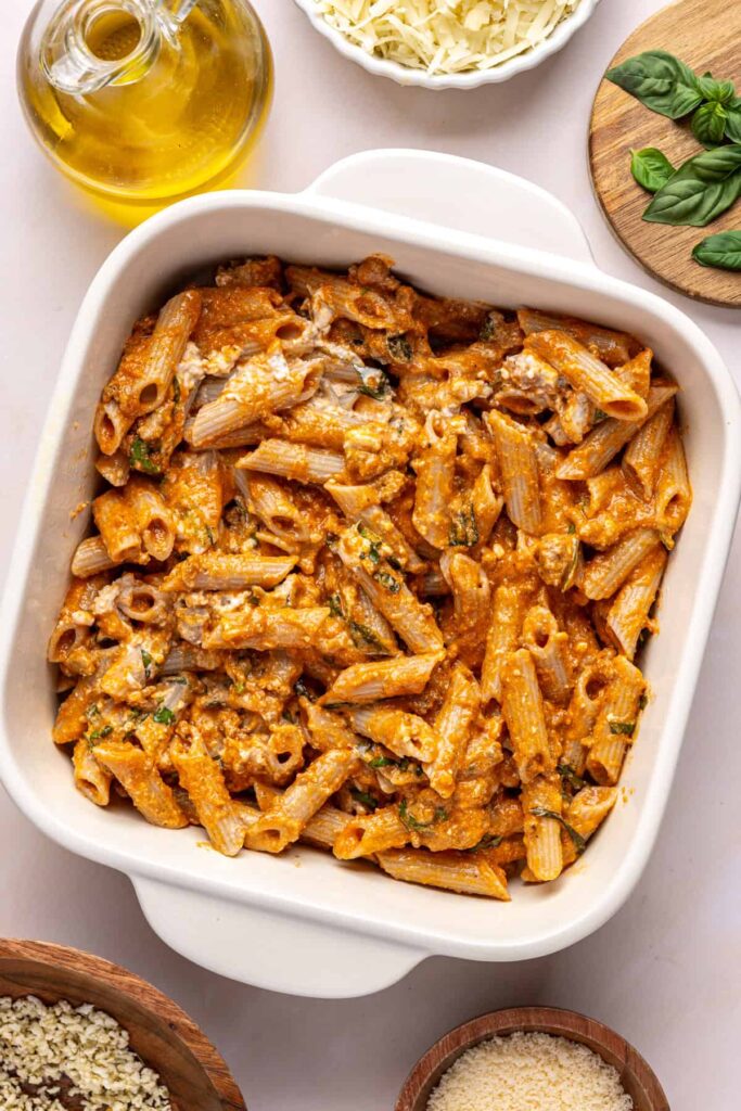 Layering pasta and mozzarella in a baking dish for easy baked ziti