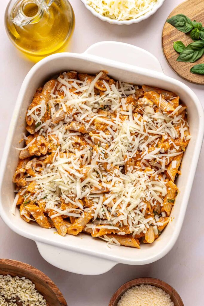 Layering pasta and mozzarella in a baking dish for easy baked ziti