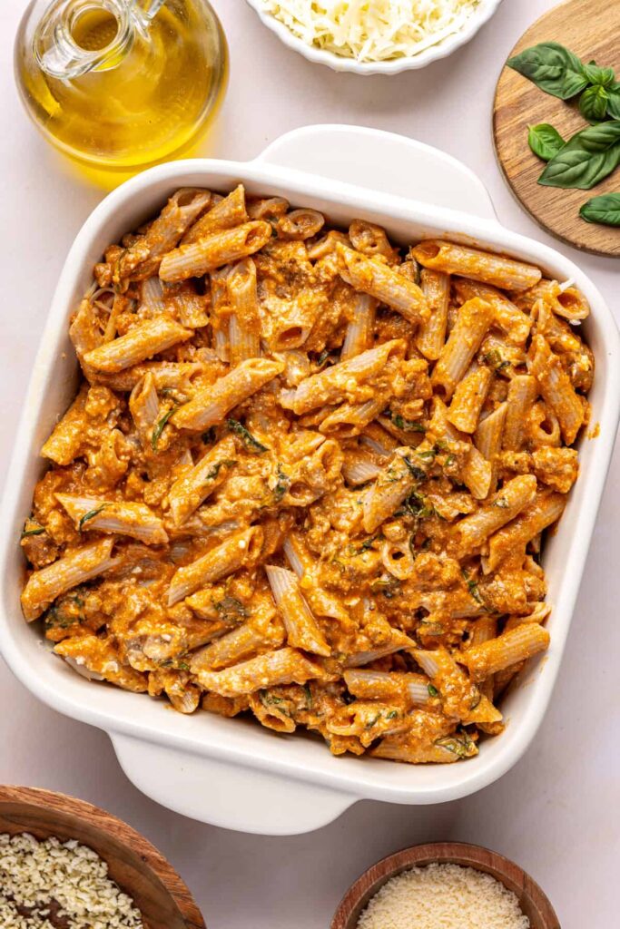 Layering pasta and mozzarella in a baking dish for easy baked ziti