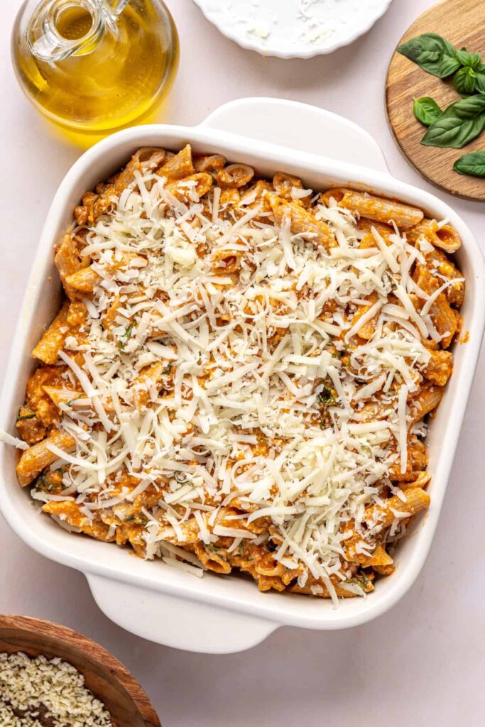 Layering pasta and mozzarella in a baking dish for easy baked ziti