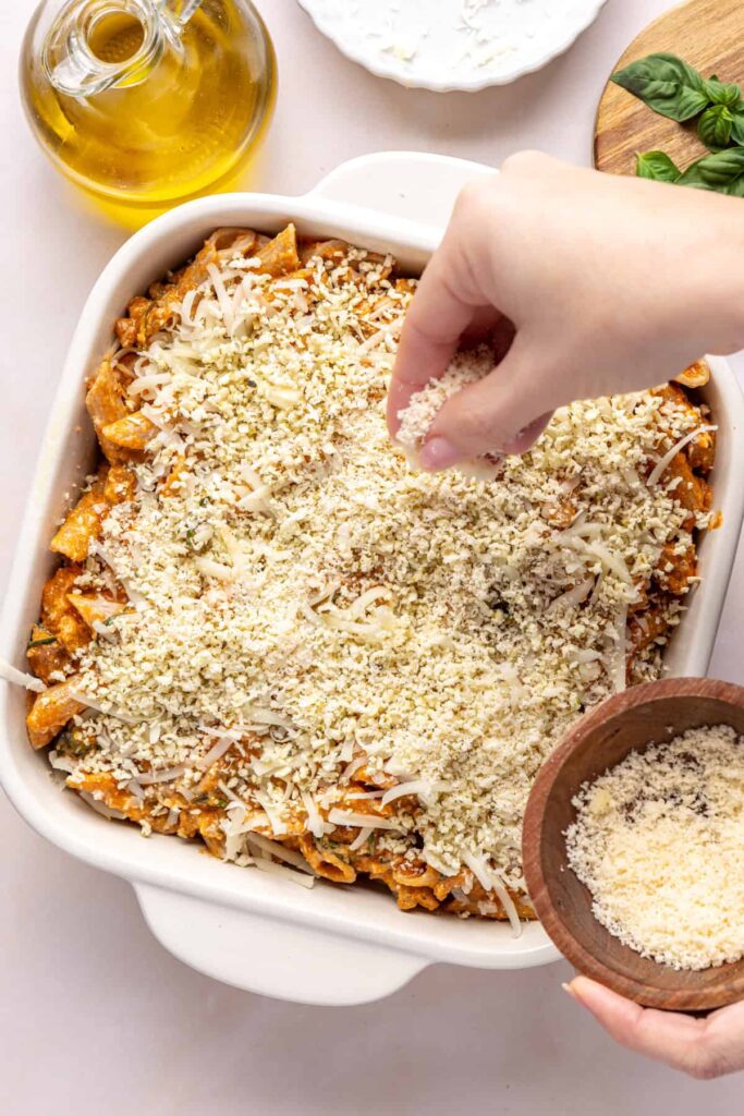 Panko and parmesan sprinkled over baked ziti before going in the oven