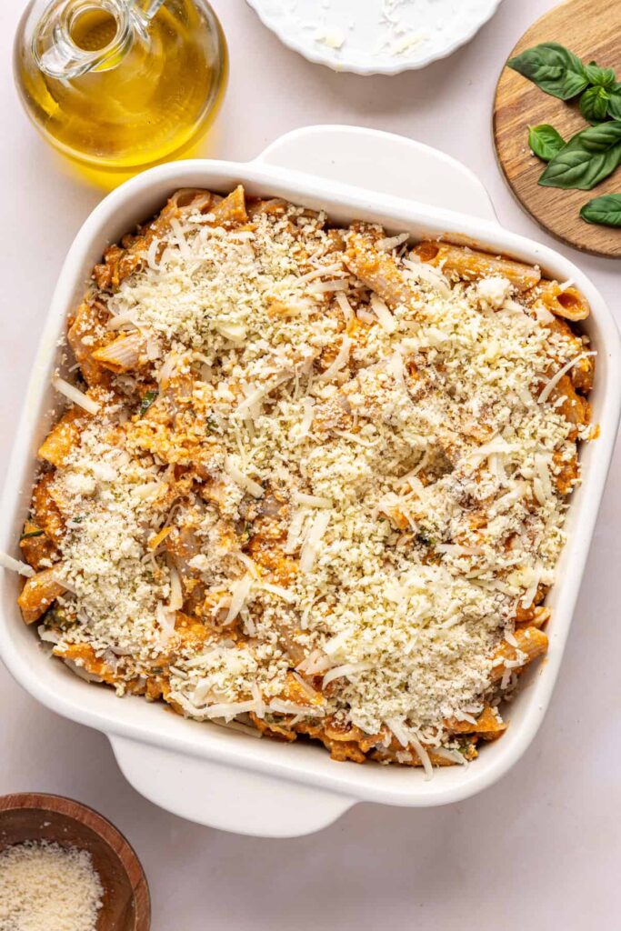 Baked ziti assembled in a square baking dish before baking