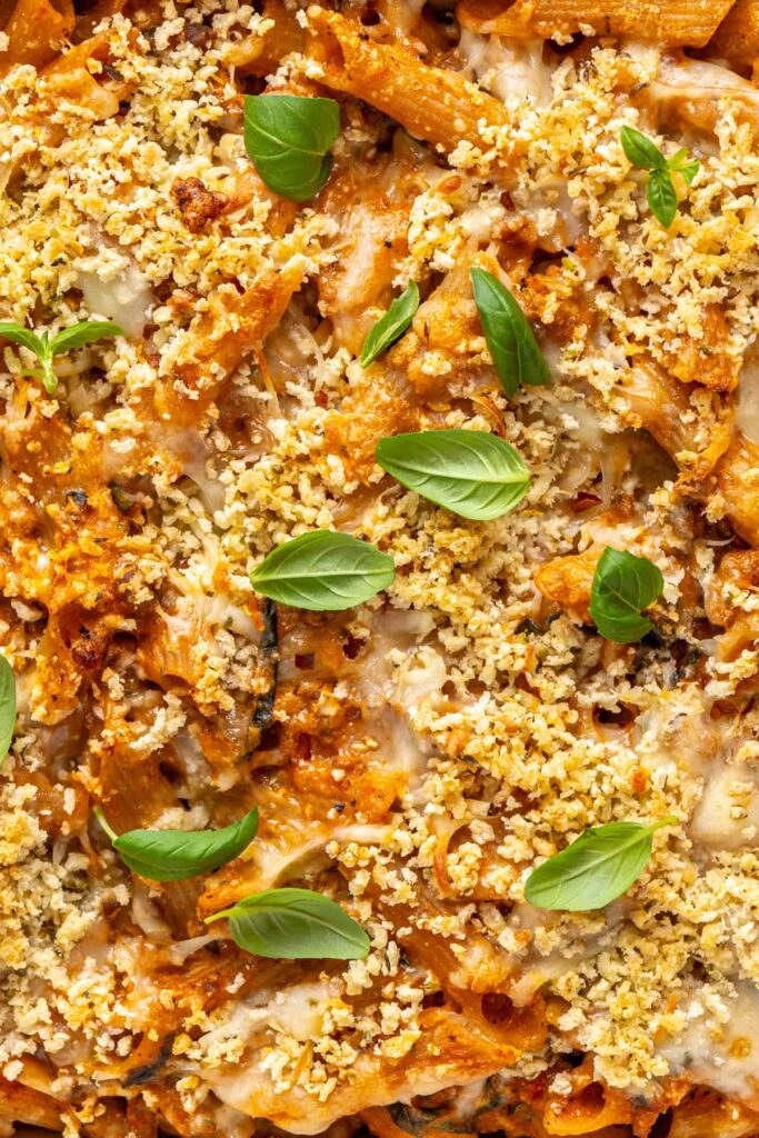 close-up overhead shot of high-protein, easy baked ziti fresh out of the oven and garnished with fresh basil
