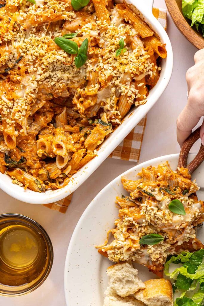 Easy baked ziti in the baking dish with a wooden spoon ready to serve