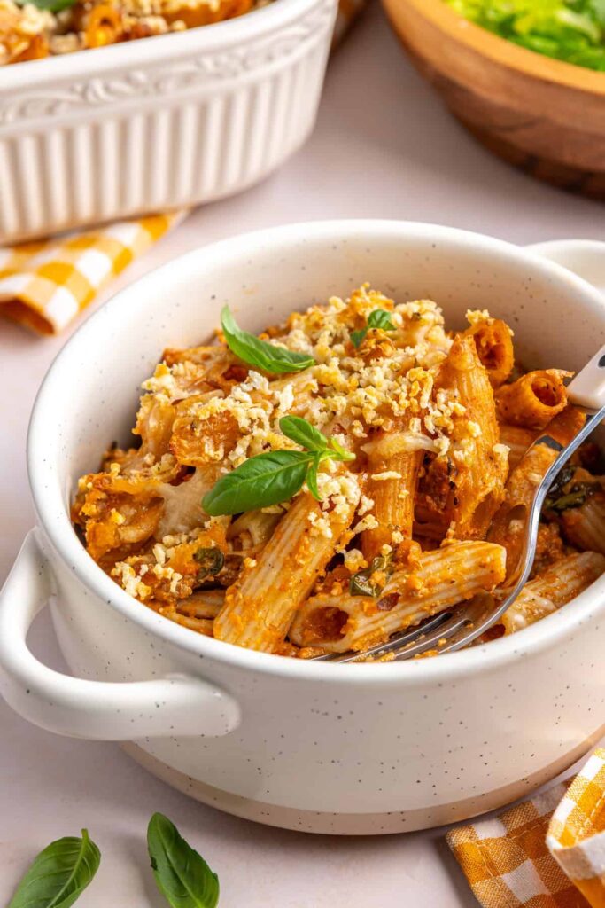 High-protein baked ziti served in a bowl with a fork
