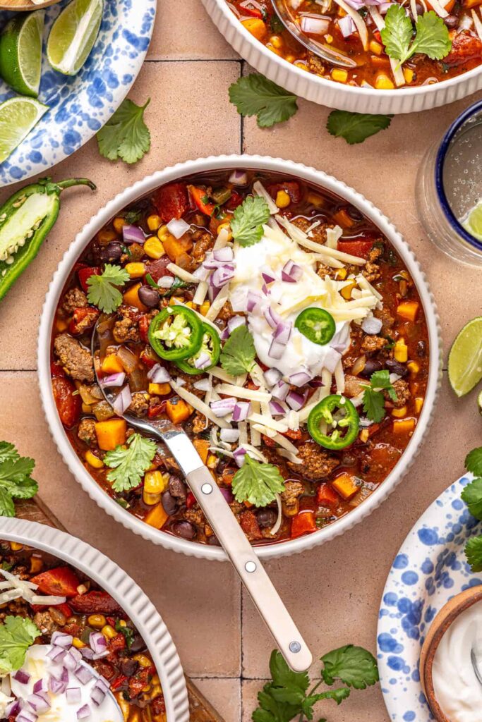 Healthy chipotle beef & black bean soup served in a bowl with a spoon