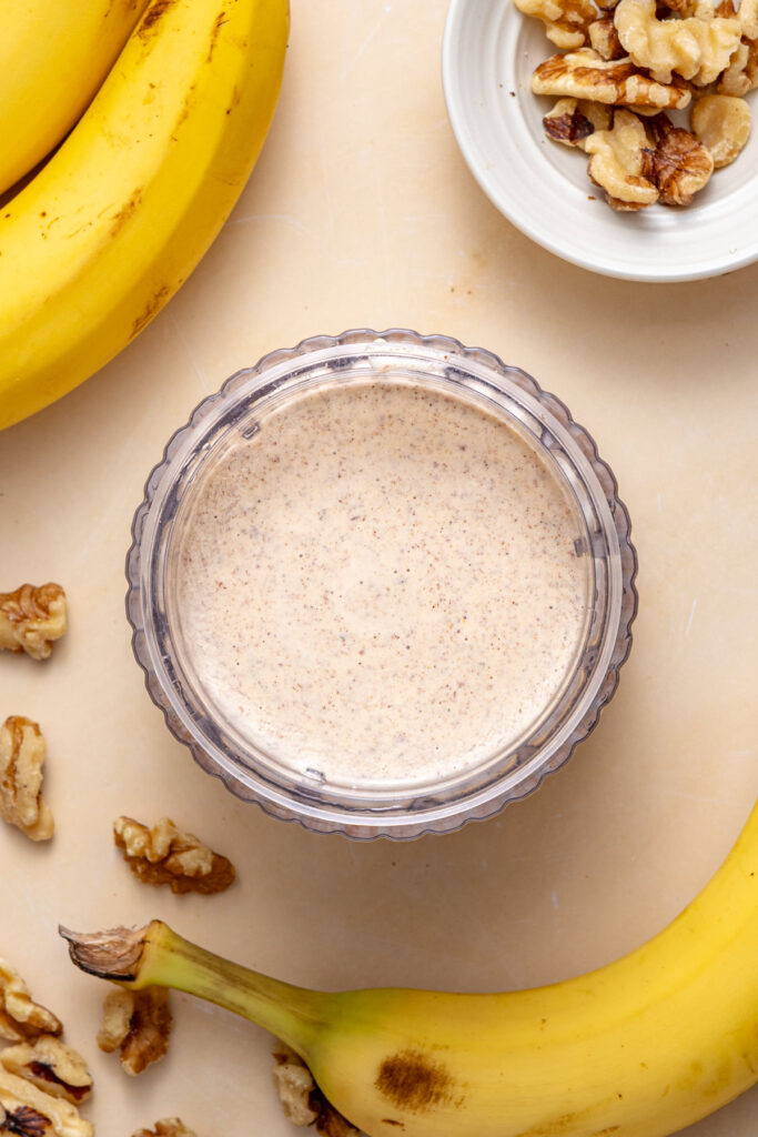 Smoothie mixture blended to creamy consistency in blender for banana nut smoothie