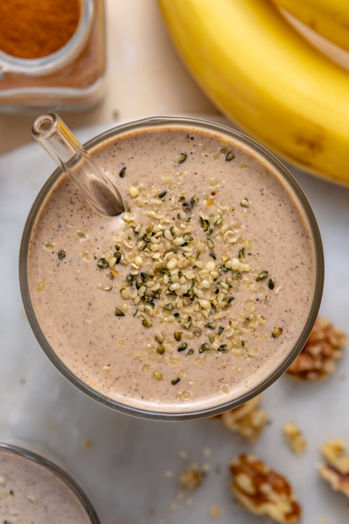 Top-down shot of banana nut smoothie with hemp seeds garnish