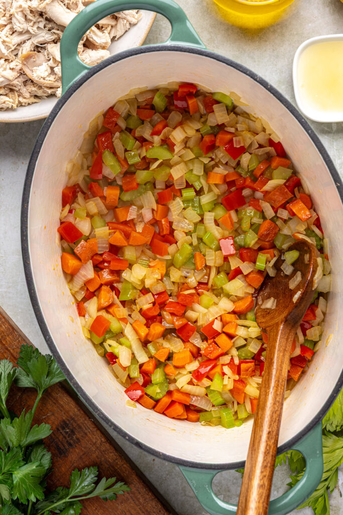 Vegetables cooking in stockpot until soft for creamy cajun chicken soup