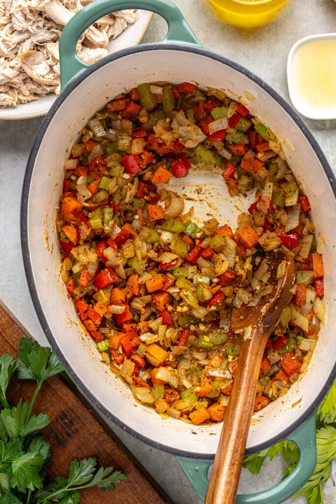 Stirring garlic, thyme, paprika, and cayenne into soup base