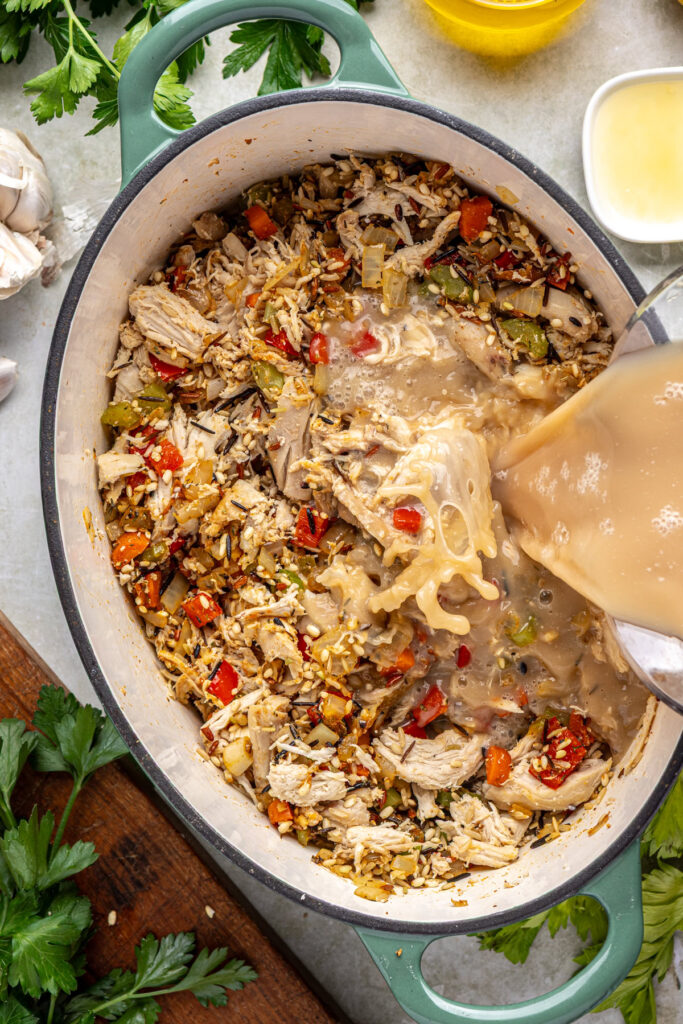 Pouring creamy bean broth mixture into stockpot for cajun chicken soup