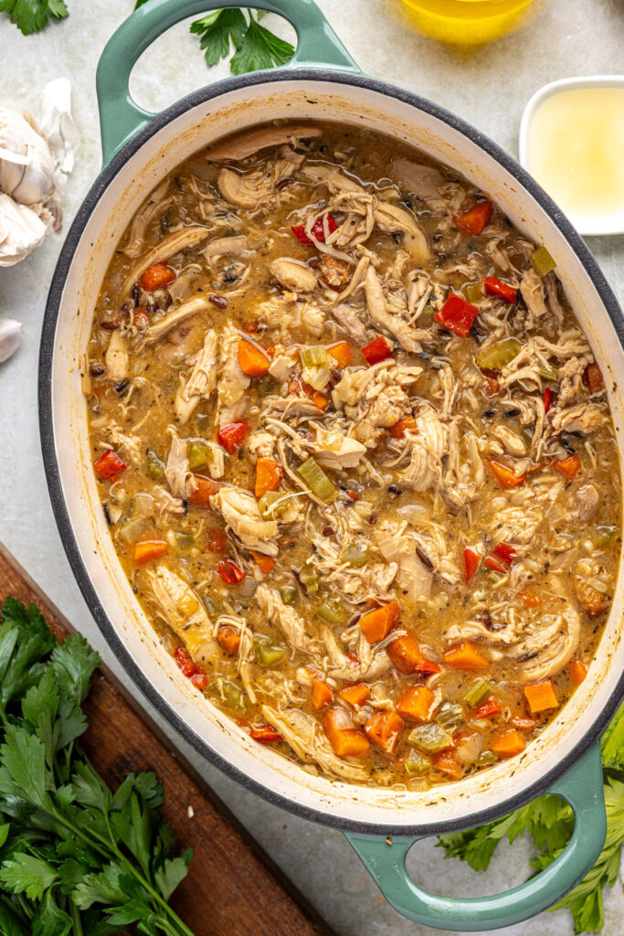 Homemade creamy cajun chicken soup simmering while flavors develop