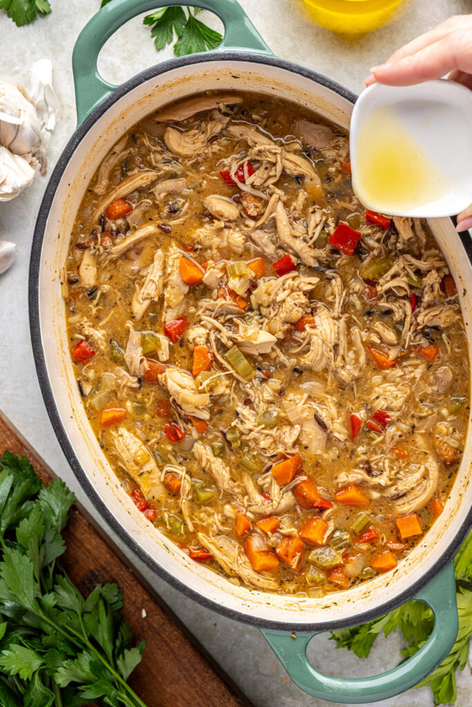 Adding fresh parsley and lemon juice to finished cajun chicken soup