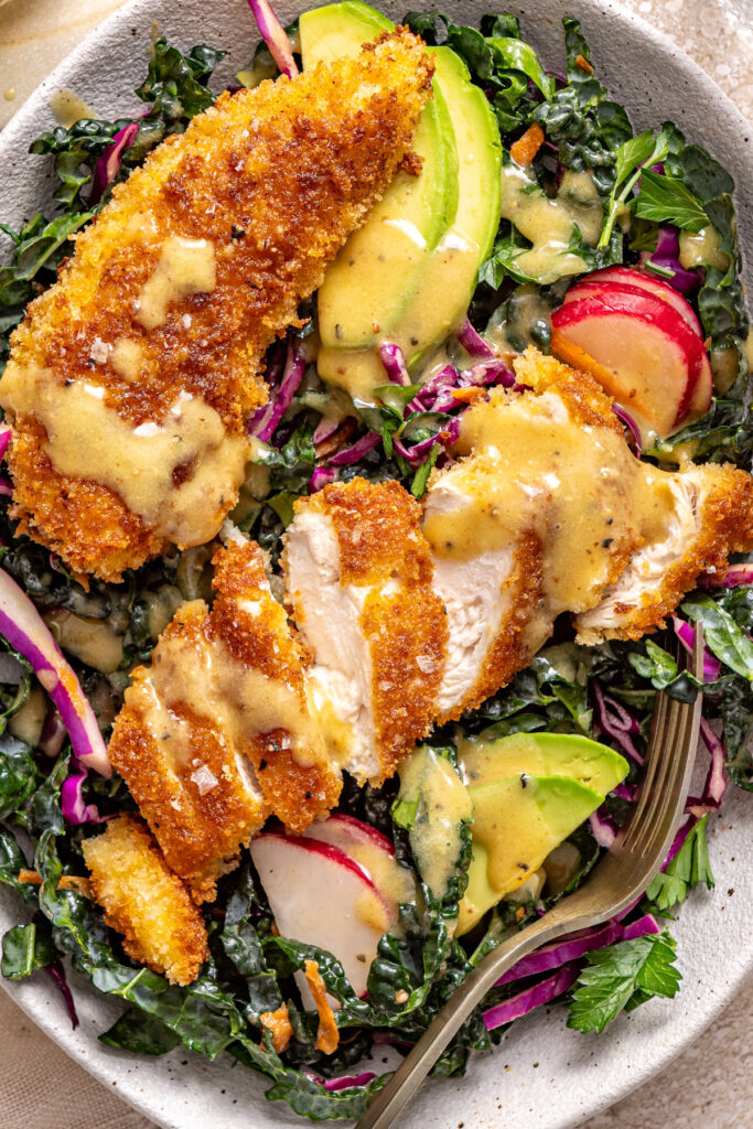 High-protein chicken kale salad with crunchy coating and creamy dressing