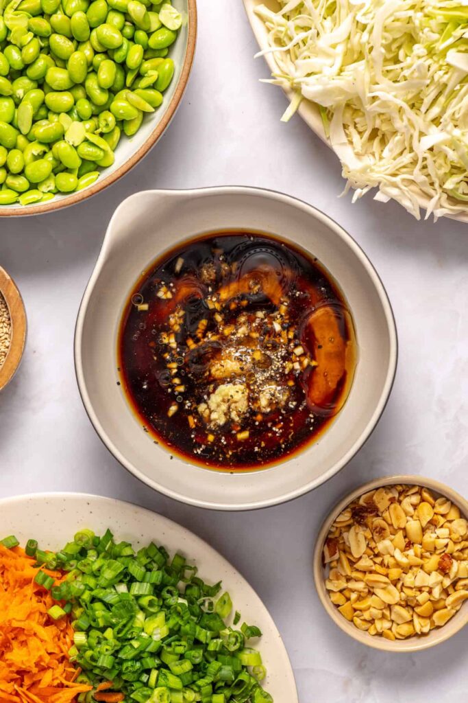 Ingredients for homemade peanut dressing in a small bowl for crunchy peanut cabbage salad