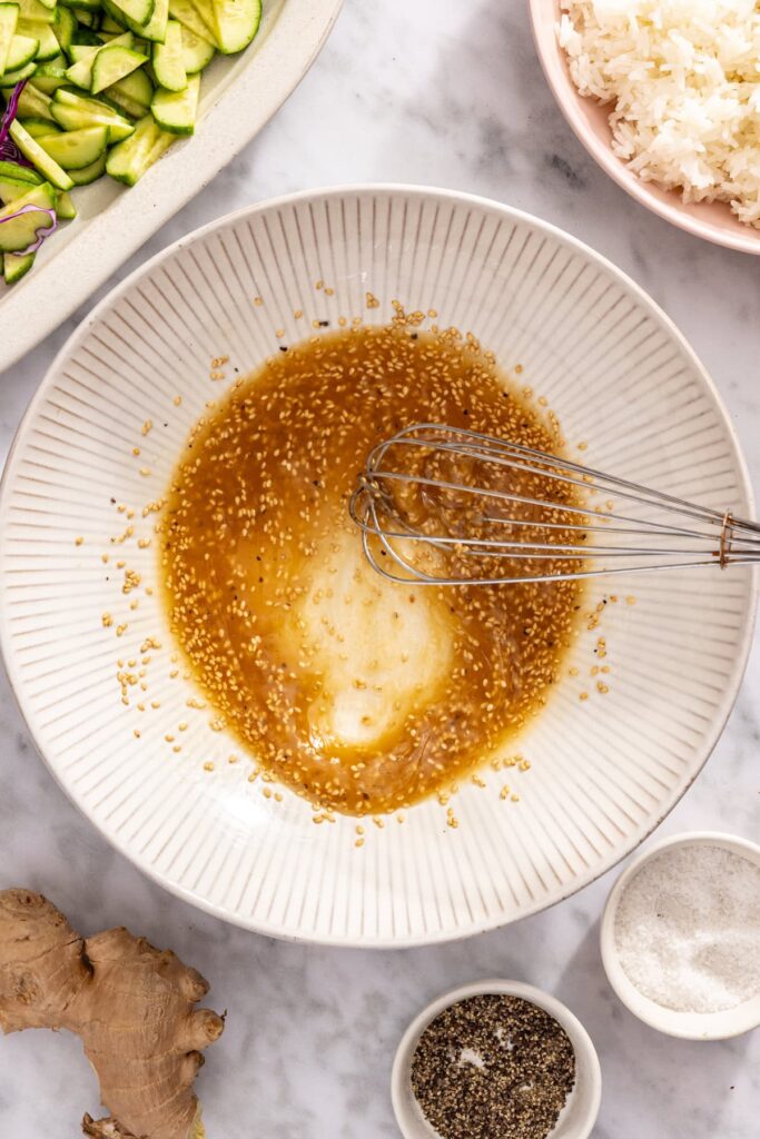 Whisking sesame oil, vinegar and honey for snap pea slaw dressing
