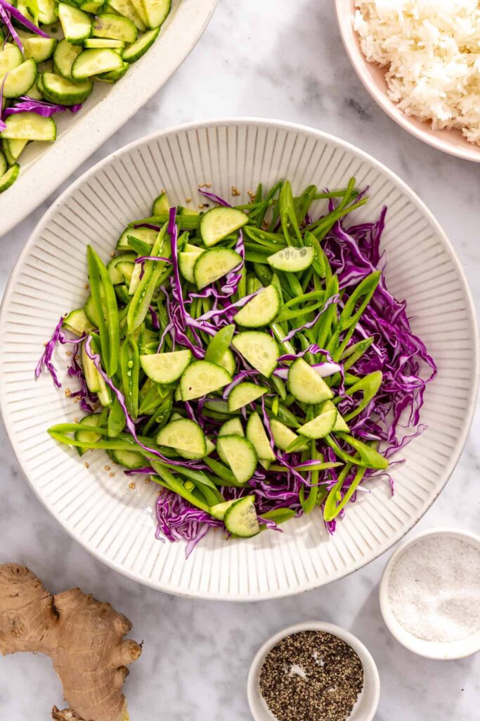 prepared ingredients for snap pea slaw in a bowl before adding dresssing