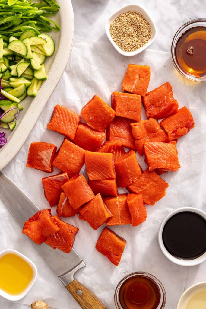 Ingredients for air fryer salmon bites with snap pea slaw arranged on a kitchen counter