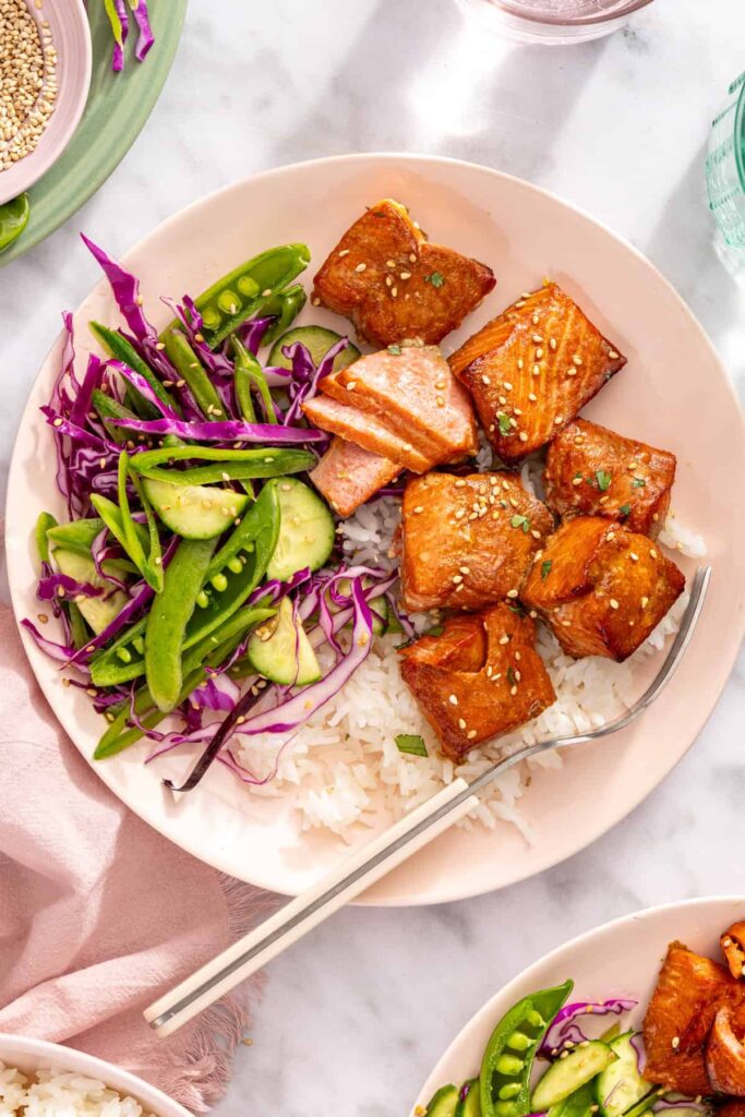 Detailed overhead of air fryer salmon bites and slaw