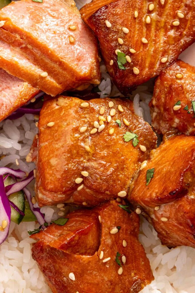 Close-up of juicy air fryer salmon bites with sesame seeds