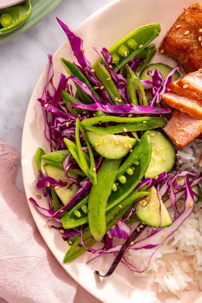 Close-up of crunchy snap pea slaw with cabbage and cucumber