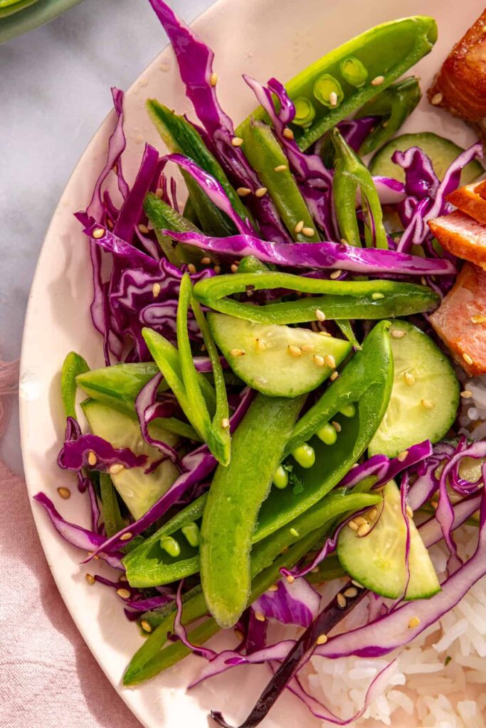 Close-up of crunchy snap pea slaw with cabbage and cucumber