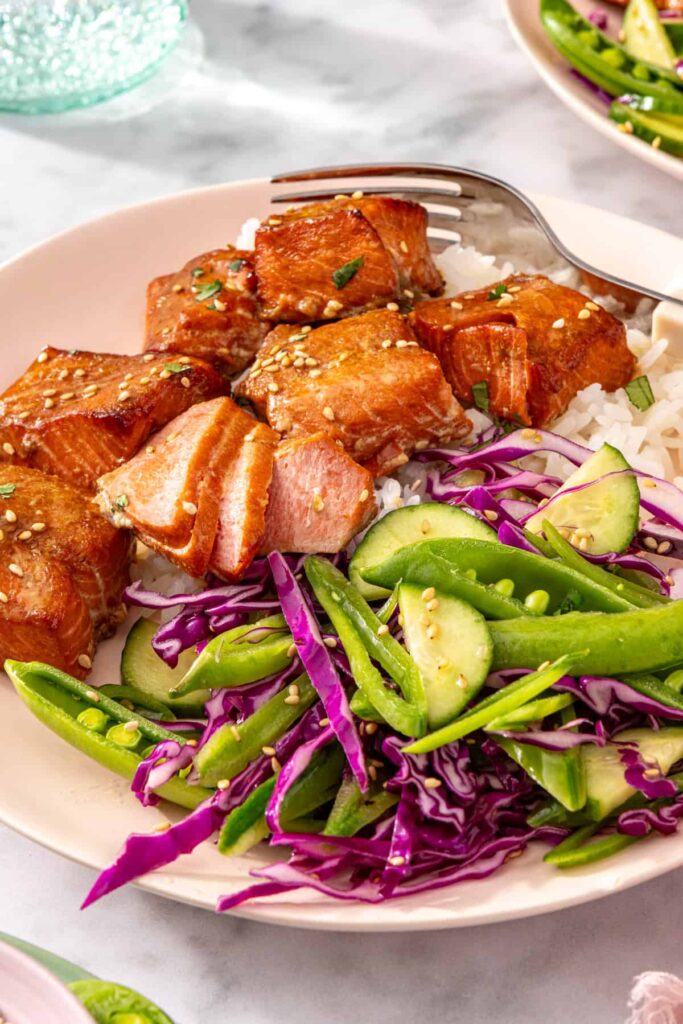 Plated salmon bites and slaw from a side perspective