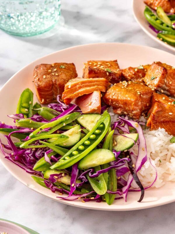 Air fryer salmon bites served with snap pea slaw and rice on a plate