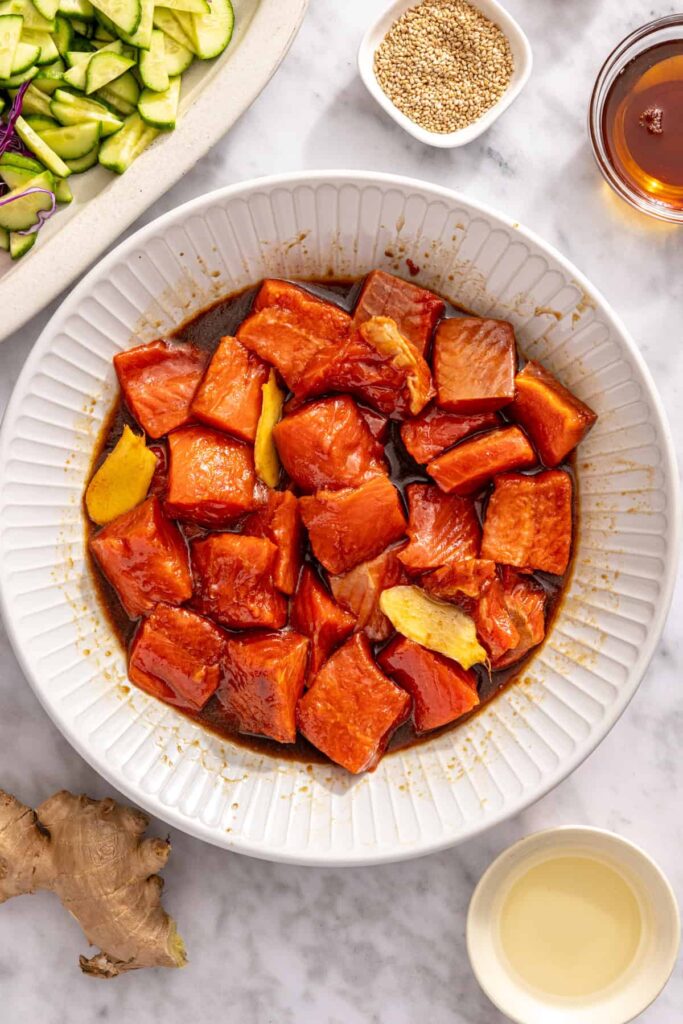 Close-up of marinated salmon bites before cooking