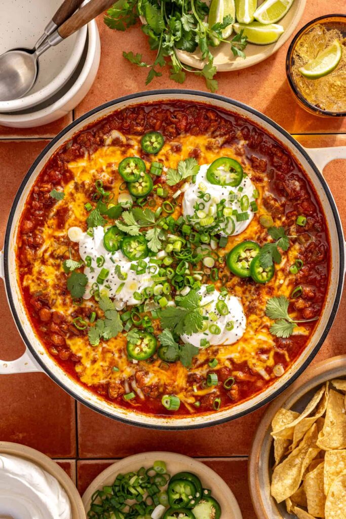 Finished chili skillet topped with fresh herbs and Greek yogurt