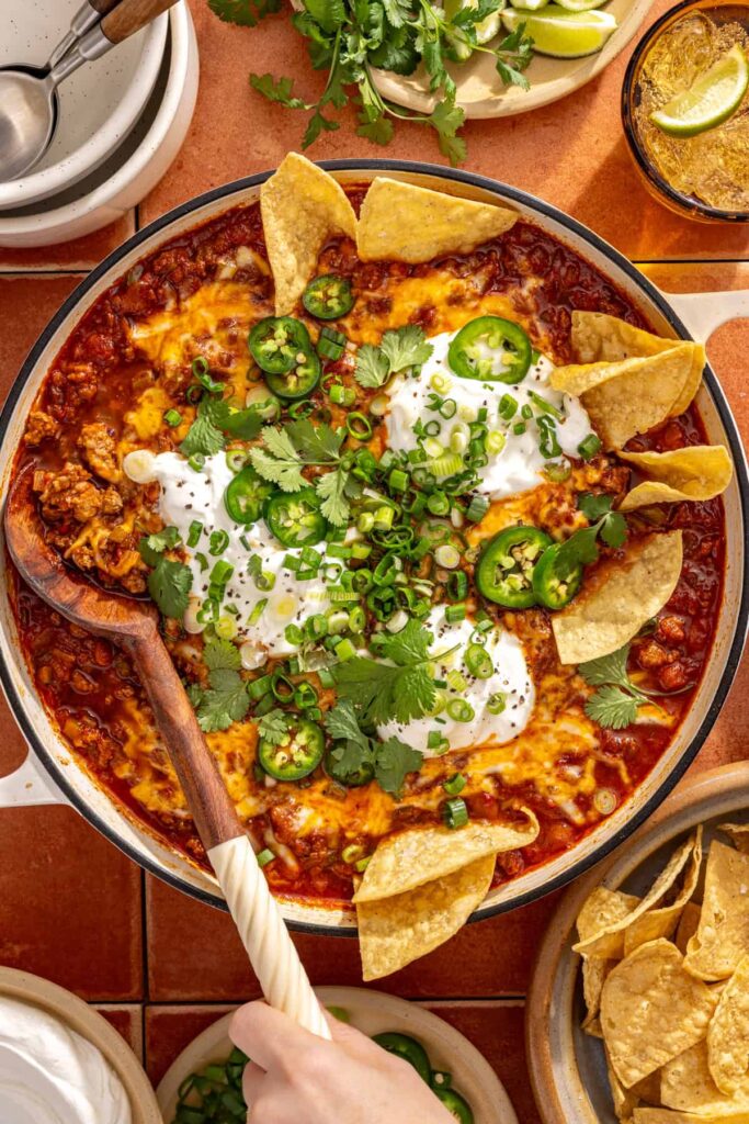 Serving chili skillet straight from skillet with spoon