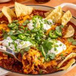 High-protein, high-fiber chili skillet styled with chips and garnishes