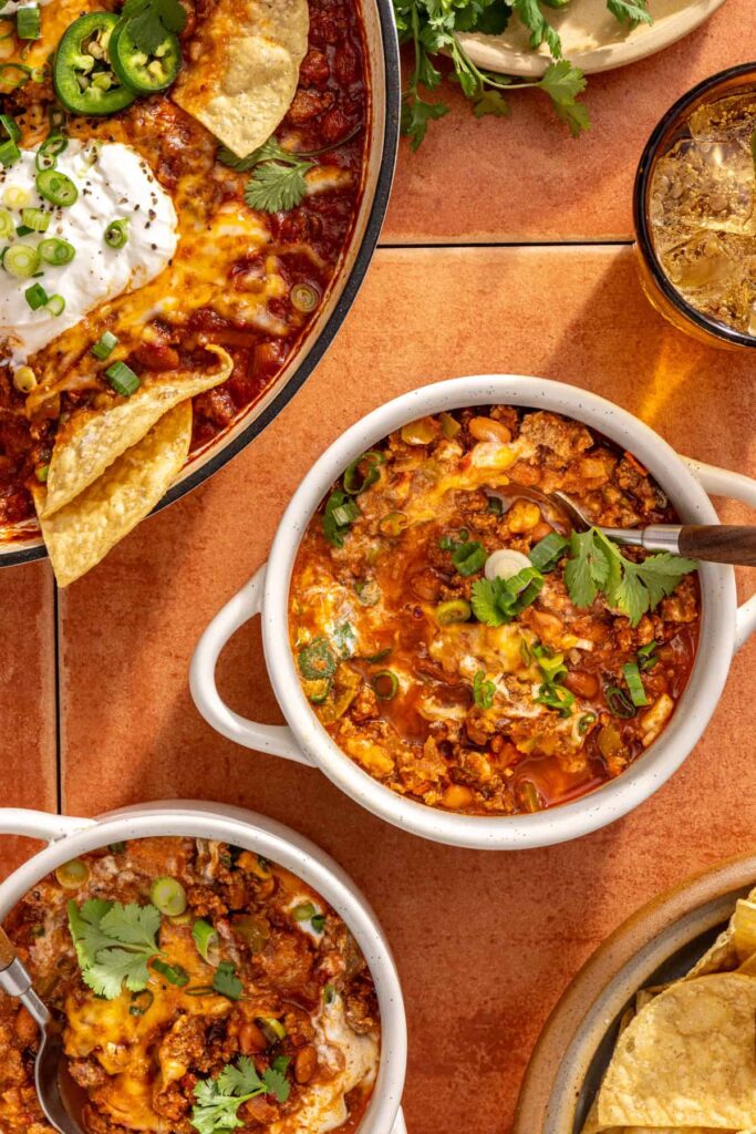 Bowl of high-protein chili skillet with Greek yogurt and herbs
