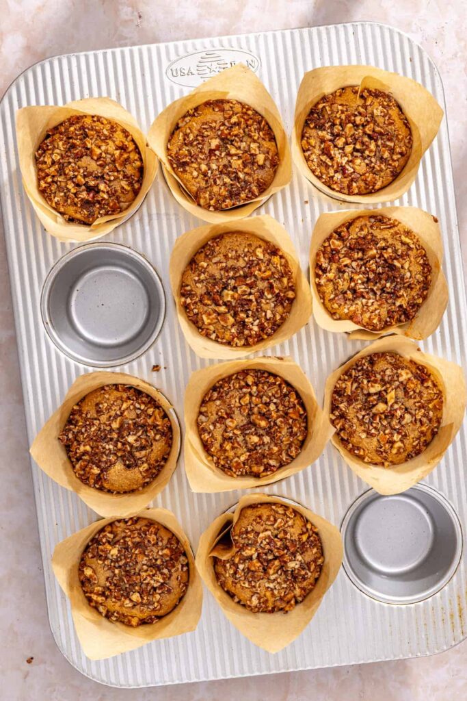 Warm coffee cake muffins with streusel topping resting in muffin pan