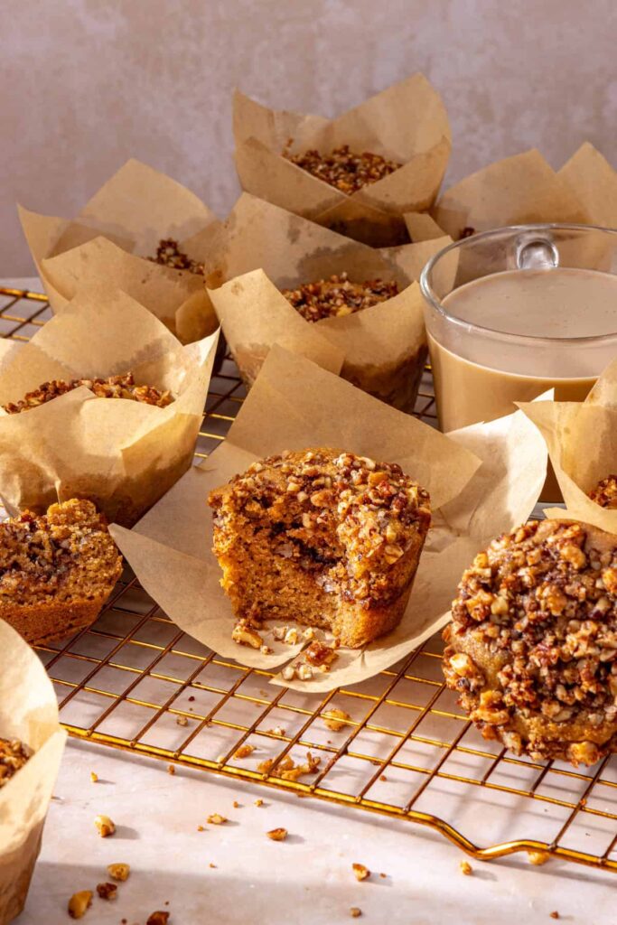Gluten-free coffee cake muffins arranged on cooling rack with coffee