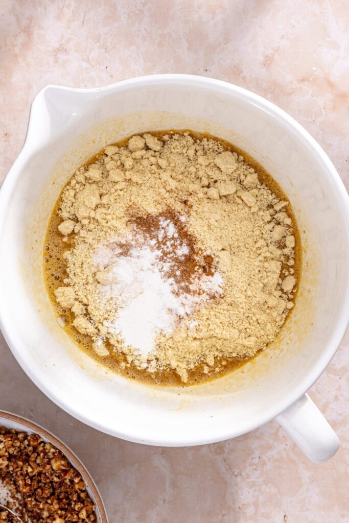 Coffee cake muffin batter being mixed until smooth with almond flour and cinnamon