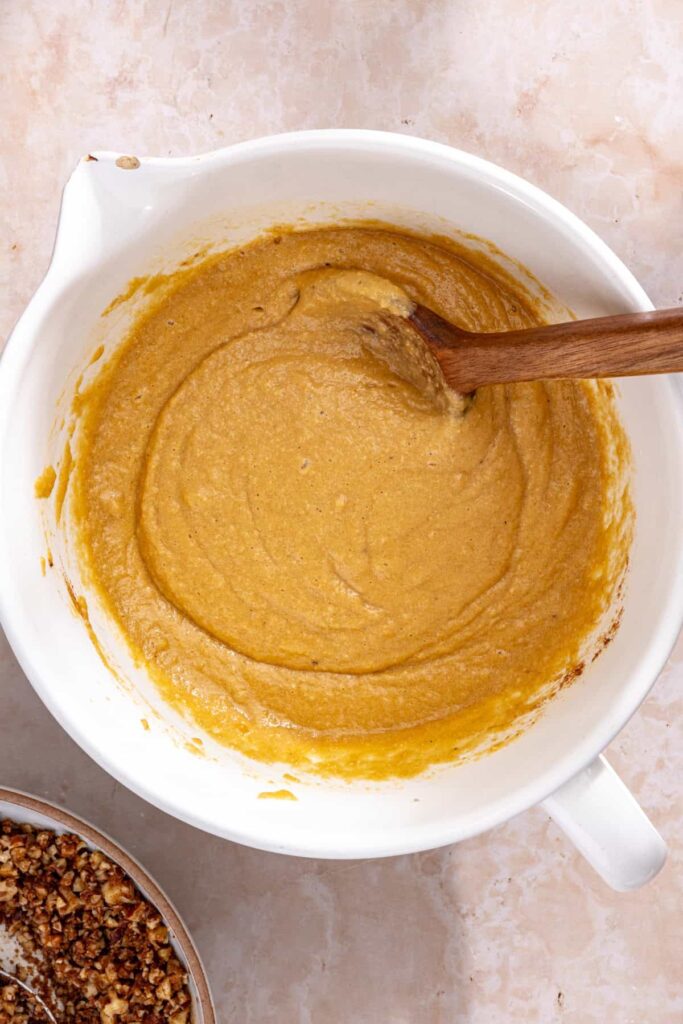 Stirring almond flour and baking powder into coffee cake muffin batter