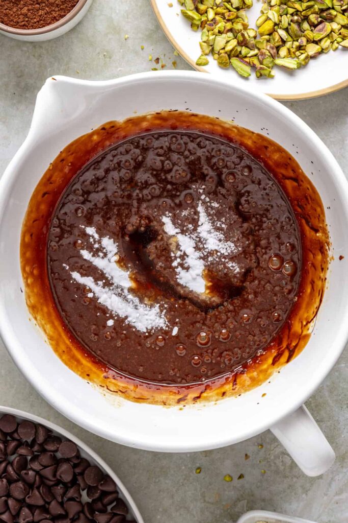 Chocolate brownie batter whisked smooth in mixing bowl