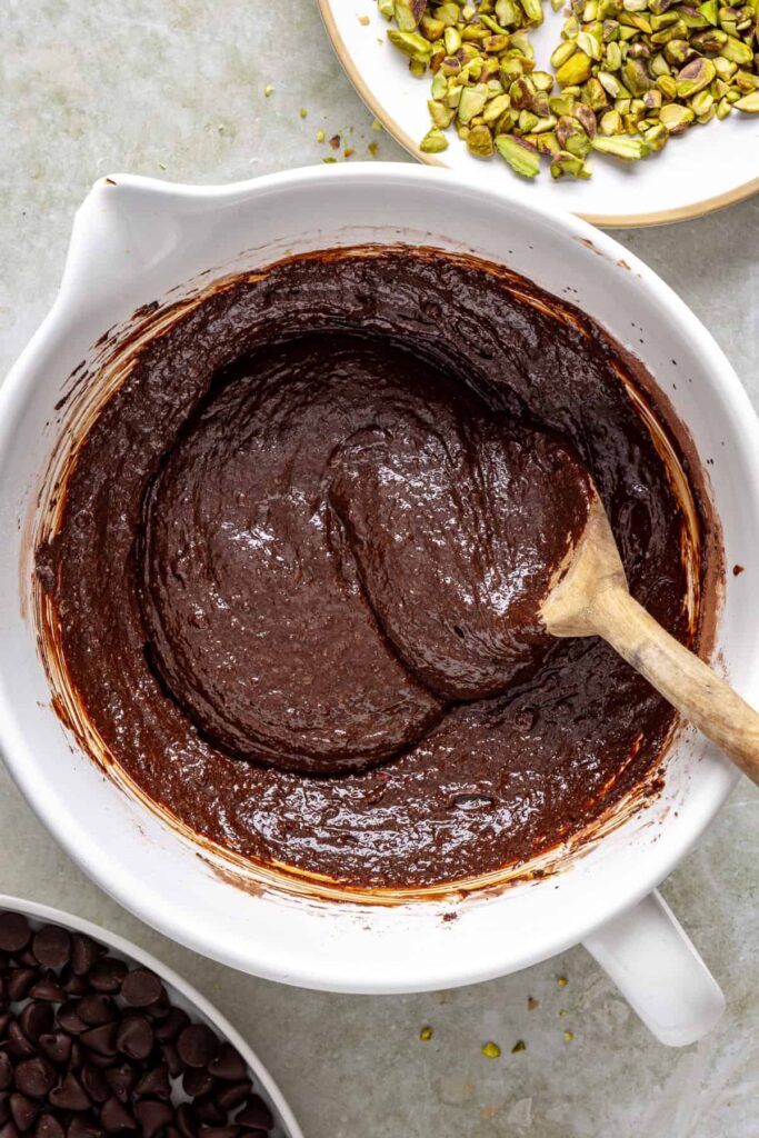 Mixing cocoa powder and arrowroot starch into gluten-free brownie batter