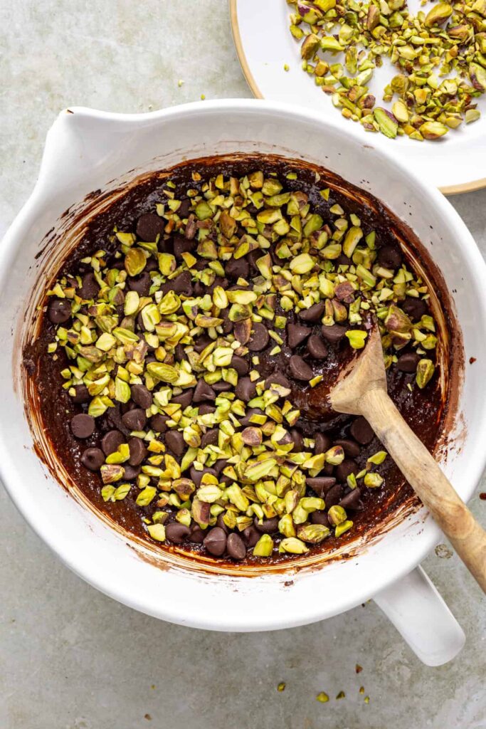 Pistachio brownie batter with chopped nuts and chocolate chips