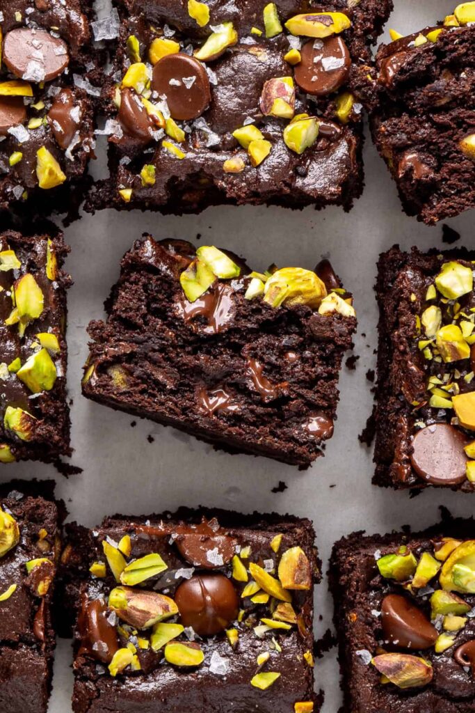Fudgy pistachio brownies cut into squares showing gooey center texture