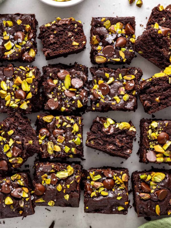 Gluten-free fudgy pistachio brownies styled with chopped chocolate and pistachios