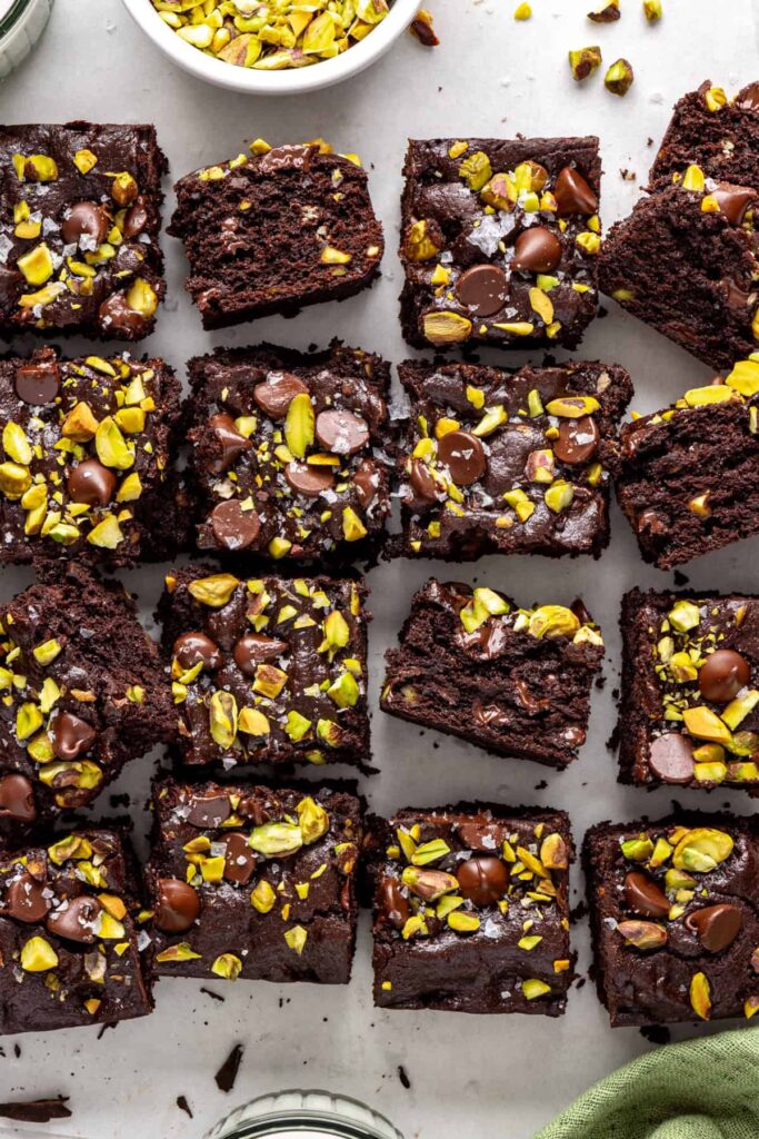Gluten-free fudgy pistachio brownies styled with chopped chocolate and pistachios