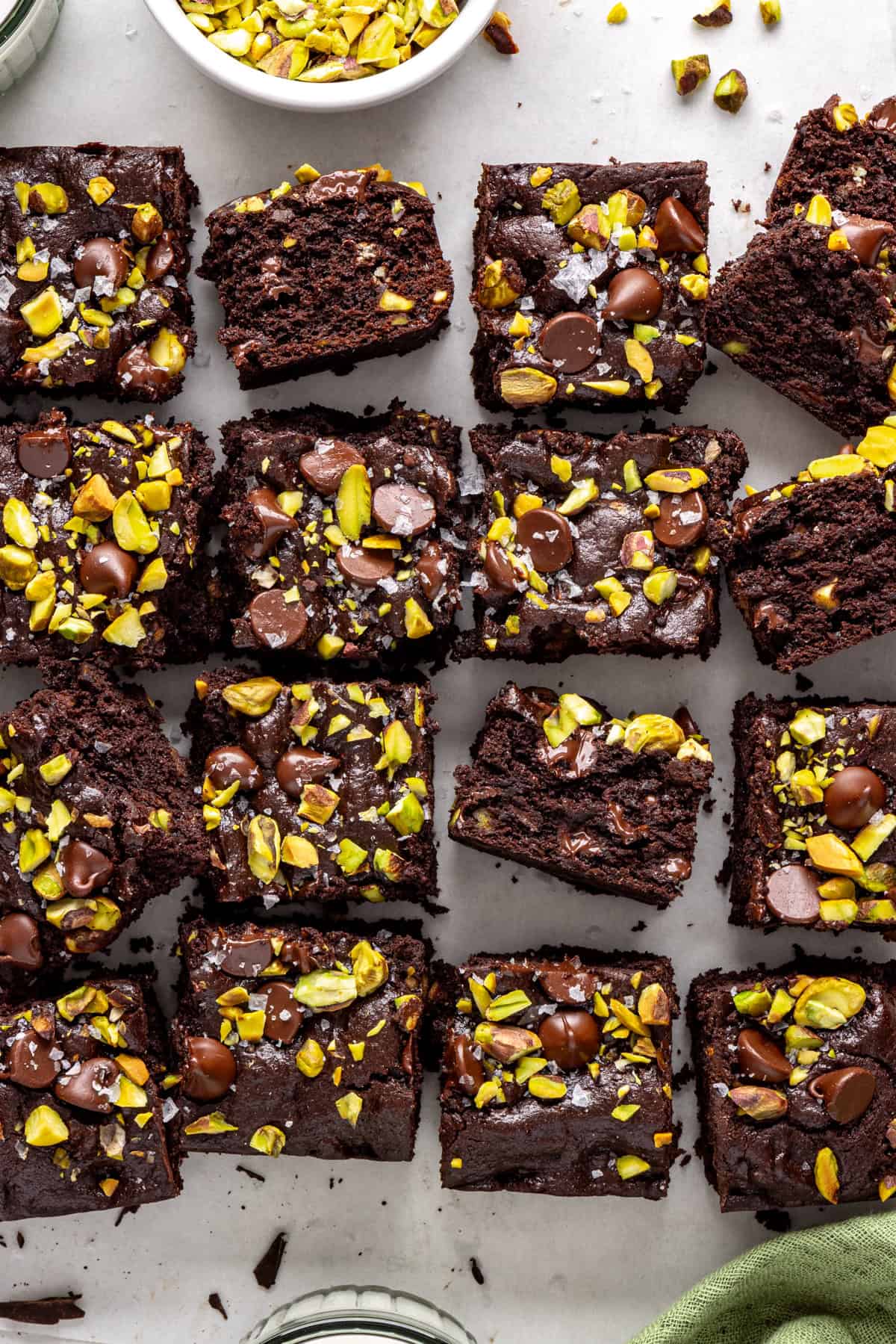 Gluten-free fudgy pistachio brownies styled with chopped chocolate and pistachios